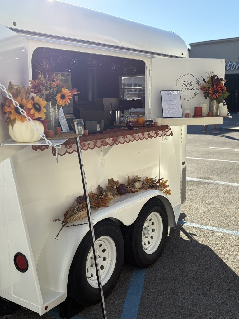 Serving smiles at a lively outdoor gathering.
